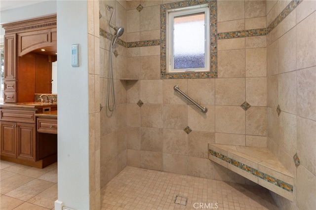 full bathroom featuring vanity and a tile shower