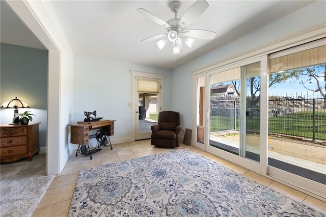 sitting room featuring tile patterned flooring, carpet flooring, baseboards, and ceiling fan