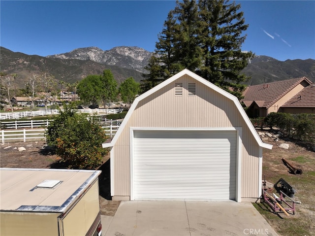 detached garage with fence and a mountain view