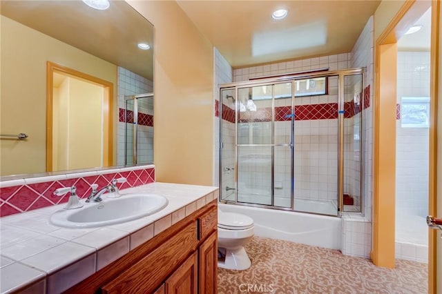 full bathroom featuring enclosed tub / shower combo, toilet, vanity, and recessed lighting