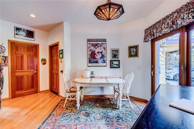 dining space with baseboards, light wood-style floors, and recessed lighting