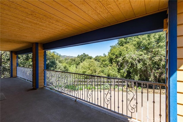 balcony featuring a forest view