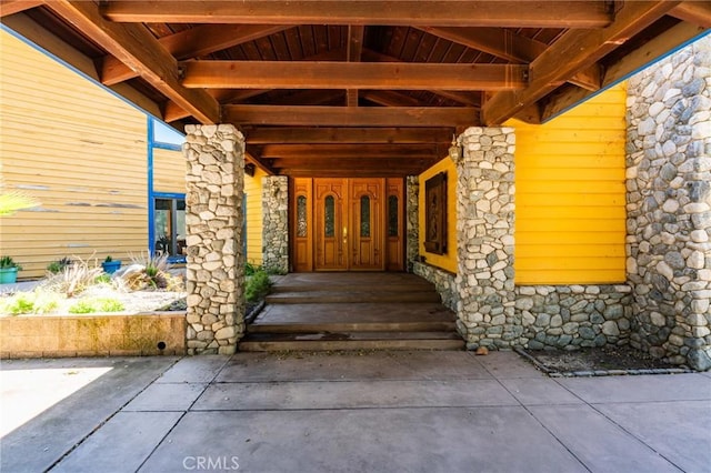view of exterior entry featuring stone siding