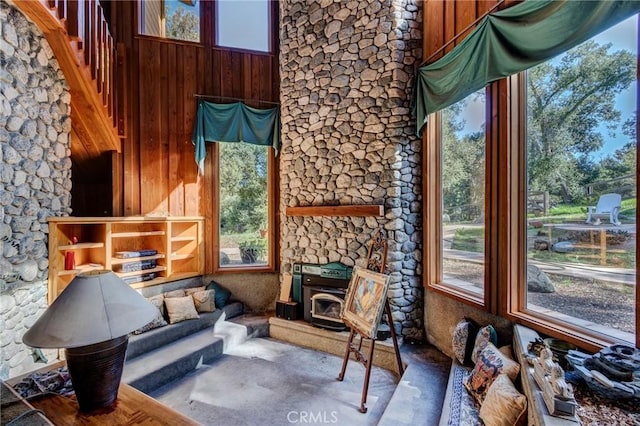 sunroom / solarium with a wood stove and plenty of natural light