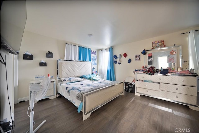 bedroom featuring multiple windows and wood finished floors