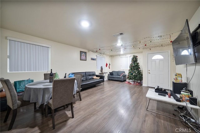 dining area with visible vents and wood finished floors