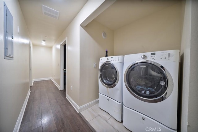 laundry area featuring visible vents, light wood-style flooring, separate washer and dryer, baseboards, and laundry area