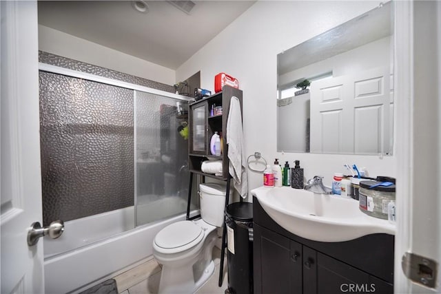 full bathroom with vanity, toilet, and shower / bath combination with glass door