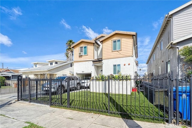 view of front of property with a front yard, a residential view, a fenced front yard, and stucco siding