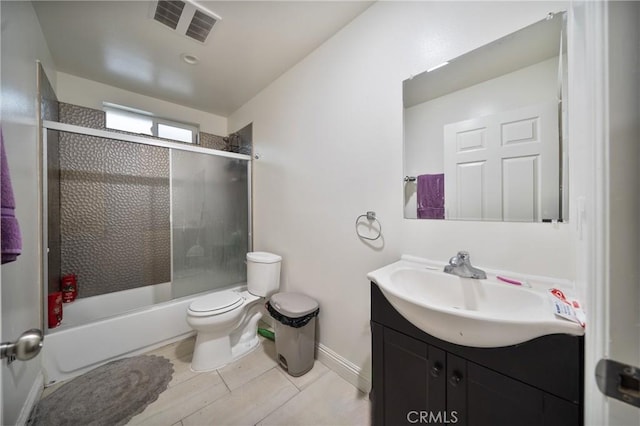 full bathroom featuring visible vents, baseboards, toilet, shower / bath combination with glass door, and vanity