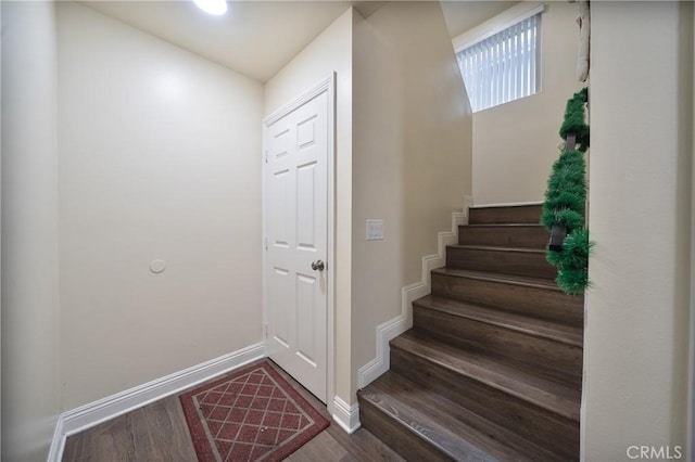 stairs featuring baseboards and wood finished floors