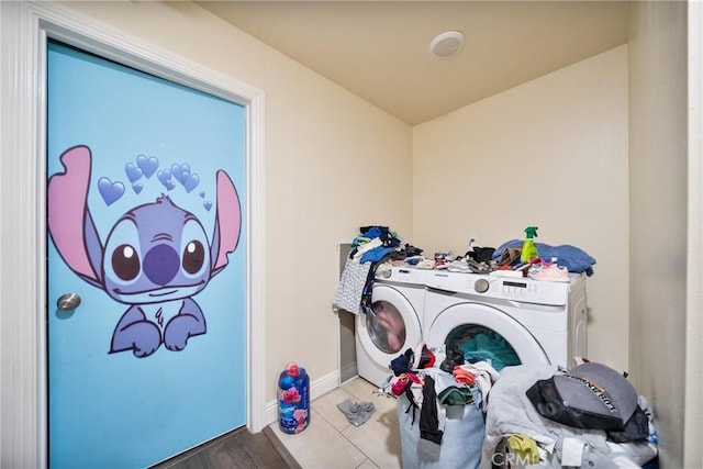 laundry room featuring laundry area, baseboards, and separate washer and dryer