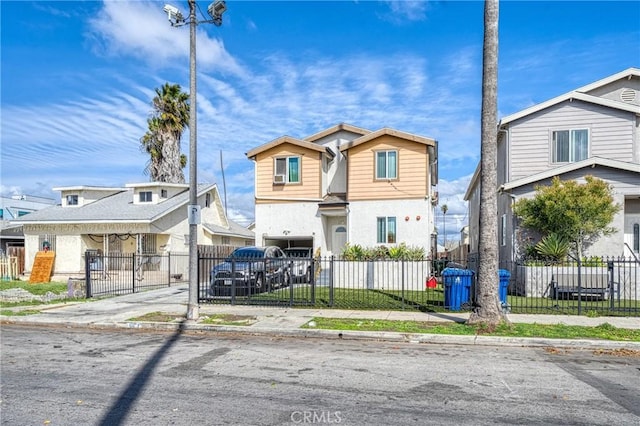 view of front of home with a fenced front yard, a residential view, and stucco siding