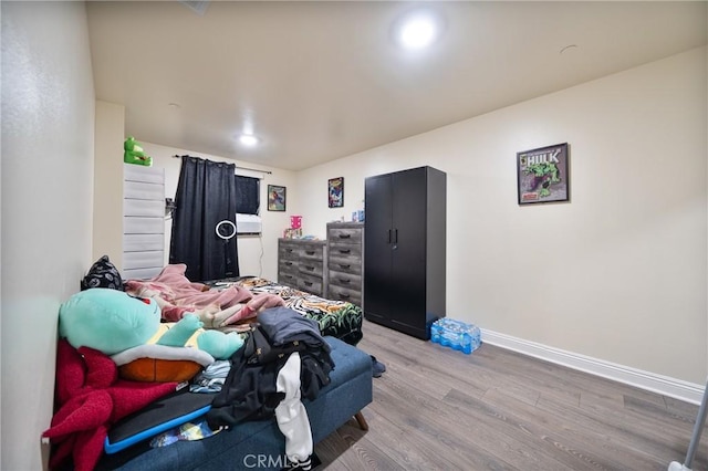 bedroom featuring light wood-style flooring and baseboards