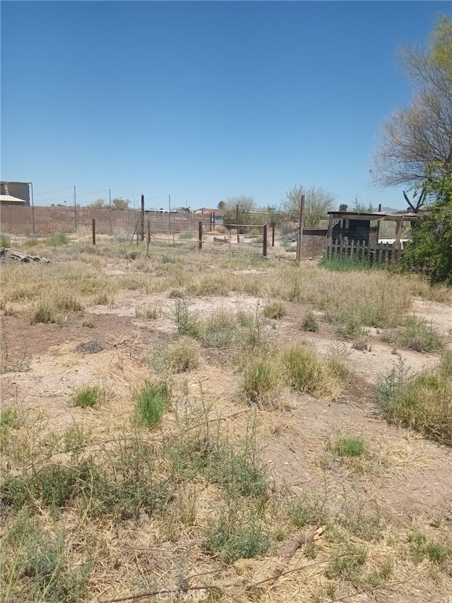 view of yard with a rural view and fence