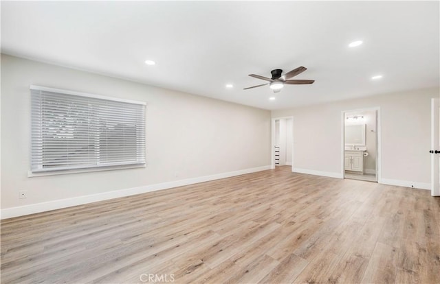 empty room featuring light wood finished floors, recessed lighting, ceiling fan, and baseboards