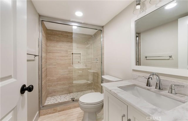 full bath featuring a shower stall, toilet, and vanity