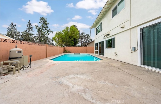 view of swimming pool featuring a fenced backyard, a fenced in pool, and a patio