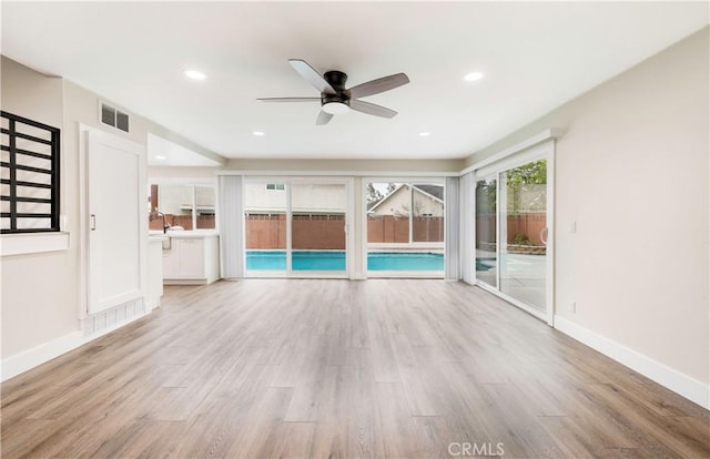 unfurnished living room featuring visible vents, wood finished floors, recessed lighting, baseboards, and ceiling fan