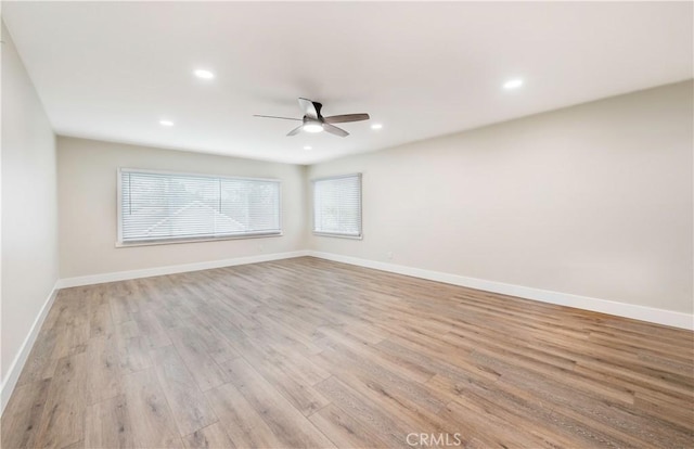 empty room with light wood finished floors, recessed lighting, baseboards, and ceiling fan