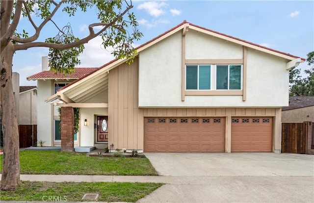 view of front of property with a front yard, fence, stucco siding, concrete driveway, and a garage