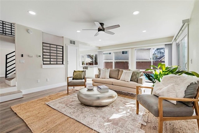 living room featuring wood finished floors, recessed lighting, a healthy amount of sunlight, and visible vents