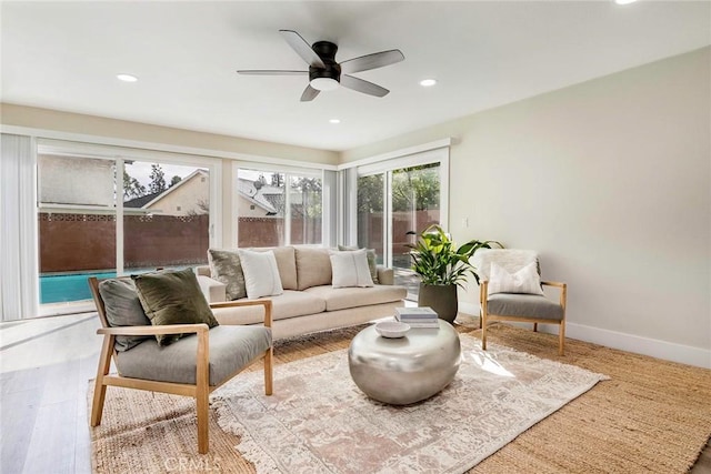 living room with recessed lighting, baseboards, wood finished floors, and a ceiling fan