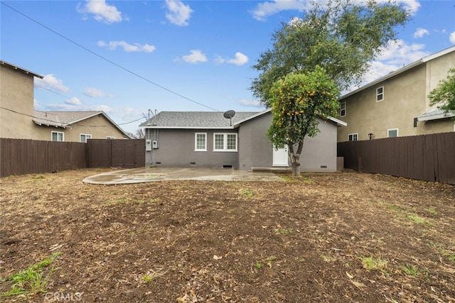 rear view of property featuring crawl space, a patio, a fenced backyard, and stucco siding