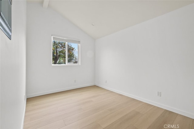 empty room featuring vaulted ceiling with beams, baseboards, and light wood finished floors