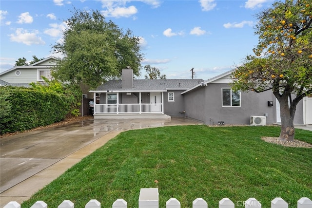 rear view of property featuring ac unit, stucco siding, a porch, a yard, and a shingled roof