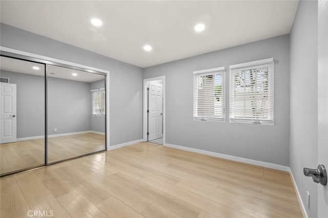 unfurnished bedroom featuring visible vents, baseboards, and light wood finished floors