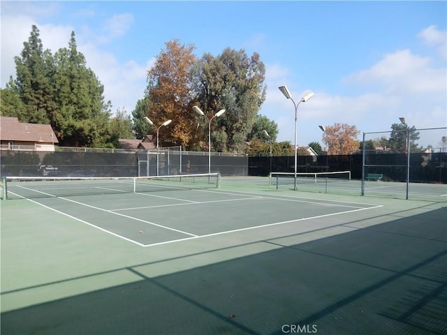 view of sport court with community basketball court and fence