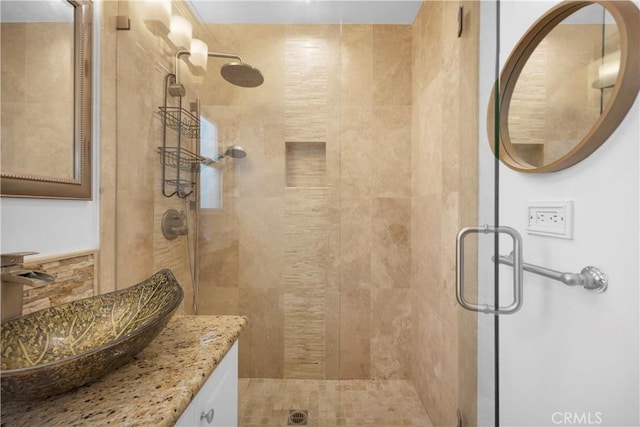 bathroom with a stall shower and vanity