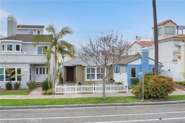 view of front of property featuring a fenced front yard and stucco siding