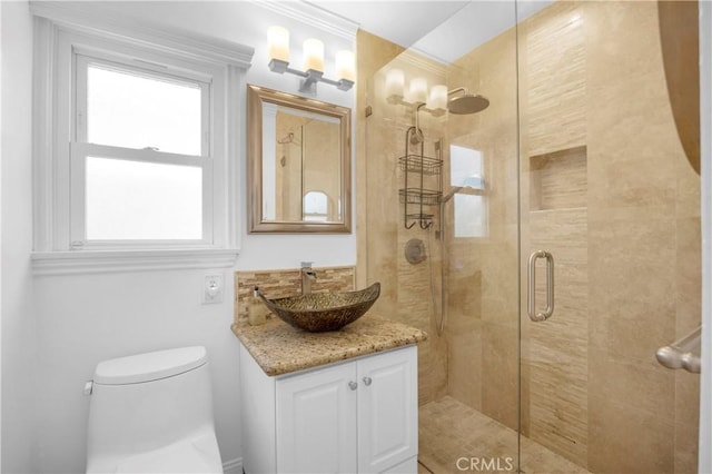 full bath with vanity, toilet, and a shower stall