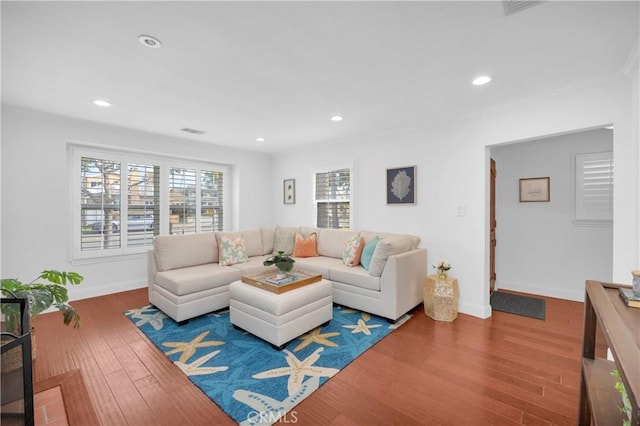 living area with visible vents, recessed lighting, baseboards, and wood finished floors