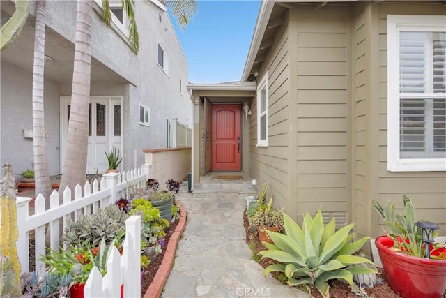 entrance to property featuring fence