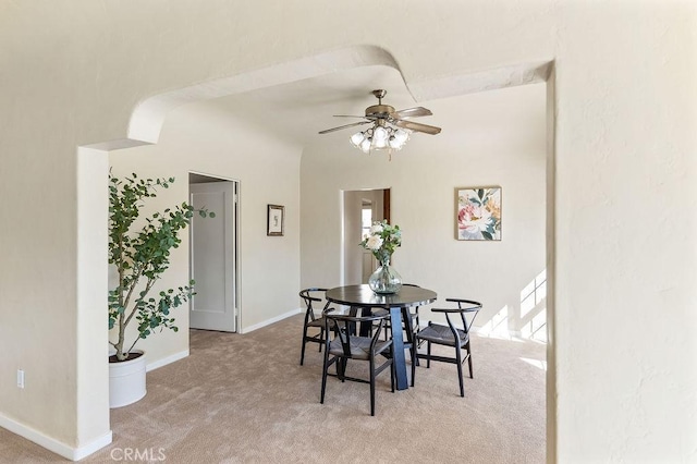 dining room with a ceiling fan, carpet, and baseboards