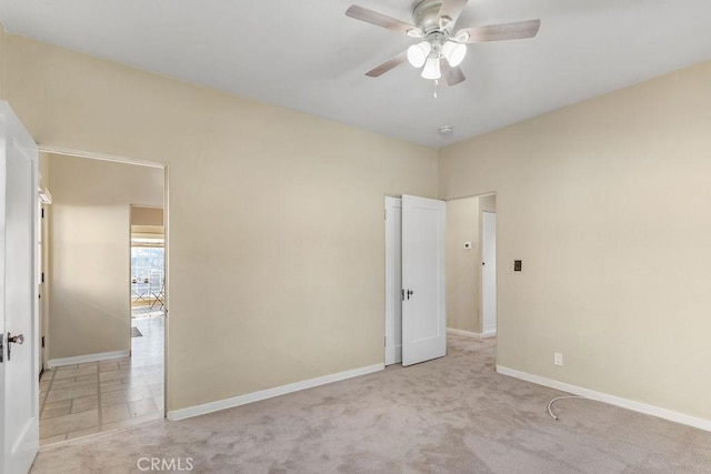 unfurnished bedroom featuring baseboards, ceiling fan, and carpet flooring