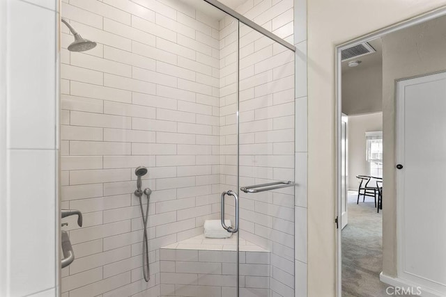 bathroom featuring visible vents and a shower stall