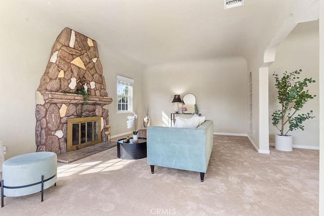 living room with carpet flooring, a fireplace, visible vents, and baseboards