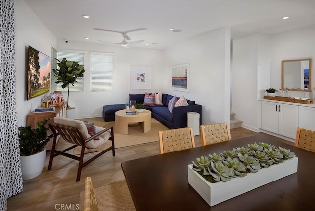 living area with a ceiling fan, recessed lighting, wood finished floors, and baseboards