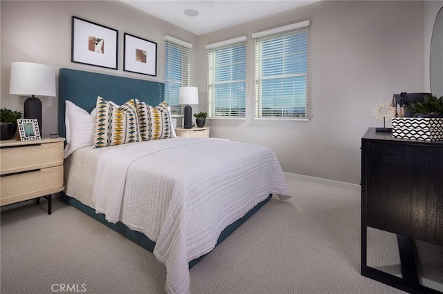 carpeted bedroom featuring baseboards