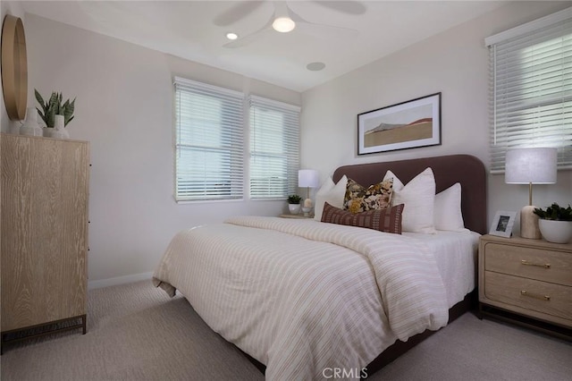 carpeted bedroom with a ceiling fan and baseboards