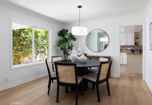22902 Via Cruz, Laguna Niguel, CA 92677 - dining space featuring light wood-style flooring, crown molding, and baseboards