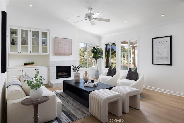 22902 Via Cruz, Laguna Niguel, CA 92677 - living area featuring light wood-type flooring, a ceiling fan, a tile fireplace, baseboards, and recessed lighting
