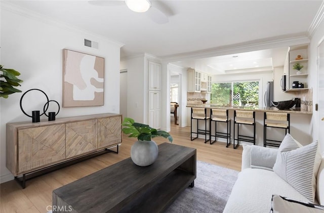 22902 Via Cruz, Laguna Niguel, CA 92677 - living room with light wood-style flooring, ornamental molding, and a ceiling fan
