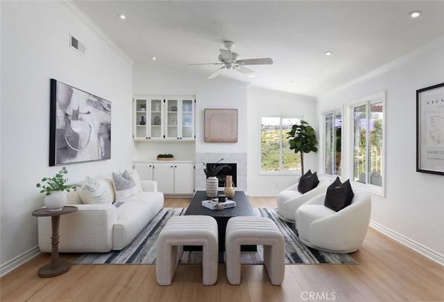 22902 Via Cruz, Laguna Niguel, CA 92677 - living area featuring light wood-type flooring, a high end fireplace, vaulted ceiling, a ceiling fan, and recessed lighting