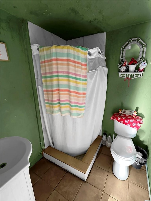 bathroom with tile patterned floors, toilet, and a shower with shower curtain