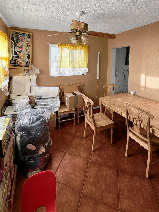 dining area with tile patterned flooring and a textured ceiling